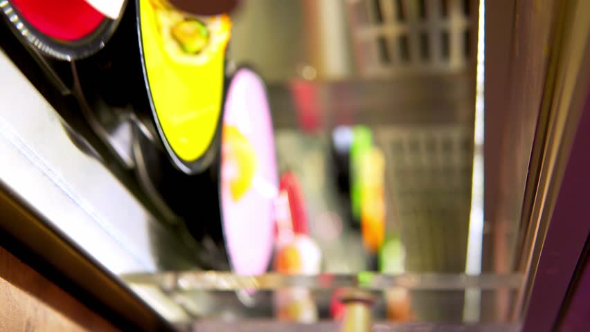 Little boy choosing among small colorful plates with sushi on a conveyor belt japanesse restaurant