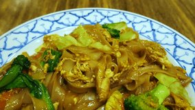 4K video of Stir fried Noodle with black soy sauce. Thailand food.