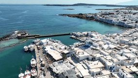 Aerial drone video from picturesque small seaside village of Naoussa with traditional Cycladic character, Paros island, Cyclades, Greece