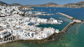 Aerial drone video from picturesque small seaside village of Naoussa with traditional Cycladic character, Paros island, Cyclades, Greece
