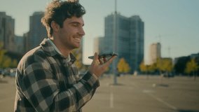 Happy Caucasian man recording voice message in smartphone walking city street smiling guy chatting with friends in mobile phone online messenger record audio voicemail with speakerphone loudspeaker - Powered by Shutterstock - Get 15% off with code: PIKWIZARD15