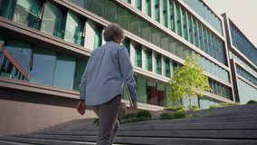 Back view gray-haired old woman business lady walking up stairs staircase outside to modern office building unrecognizable businesswoman walk outdoors climbing steps in city successful career feminism - Powered by Shutterstock - Get 15% off with code: PIKWIZARD15