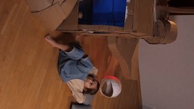 vertical little girl plays pilot, astronaut, lies on floor and thinks, dreams