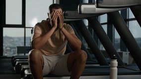 Athletic man tired exhausted African American thirsty male sportsman runner drinking water drink protein from fitness bottle refresh habit hydration in sport gym rest on treadmill run cardio exercise  - Powered by Shutterstock - Get 15% off with code: PIKWIZARD15