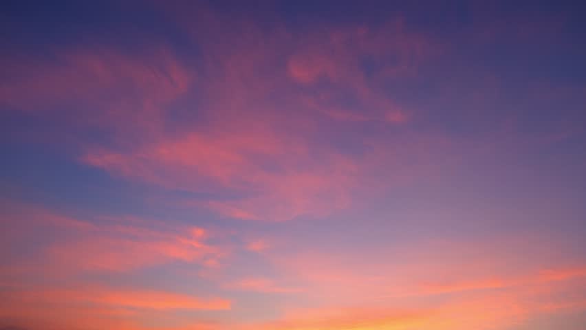 4K : Sunset sky time lapse : Timelapse footage captures the beauty of the sunset sky adorned with vibrant hues. Majestic clouds dance across the horizon, painting a picture of tranquility.
