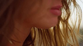 CLOSE UP, LENS FLARE: Gentle summer wind blowing through woman's long wavy hair. Rear view of beautiful young brunette, illuminated with amazing golden light, is walking towards the setting summer sun - Powered by Shutterstock - Get 15% off with code: PIKWIZARD15