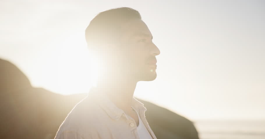 Beach, sunset and man with peace, breathing and relax on holiday or vacation in sunshine. Calm, person and enjoy fresh air outdoor in summer, nature and travel to ocean in California for break