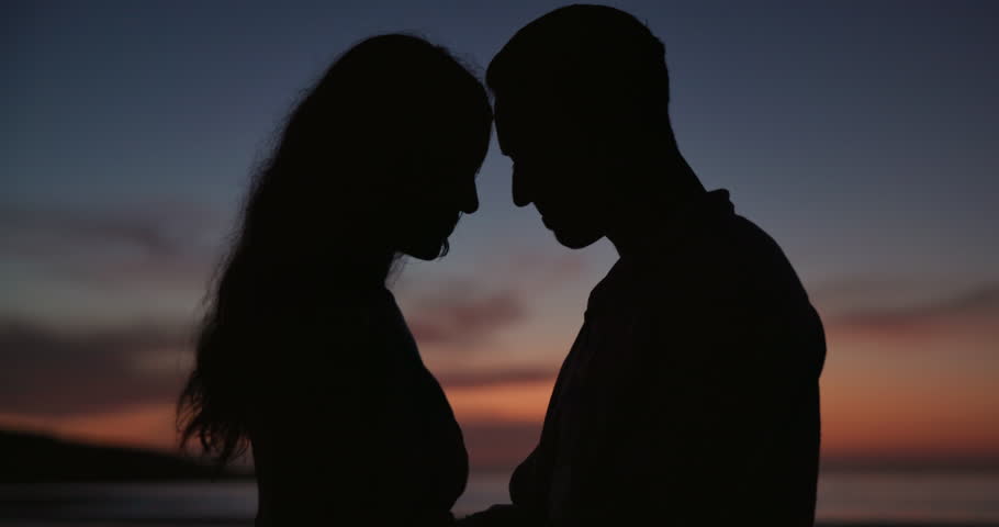 Sunset, love and silhouette of couple at beach on vacation, adventure or holiday for romantic date. Travel, care and shadow of man and woman on tropical weekend trip for valentines day together. Royalty-Free Stock Footage #3432598837