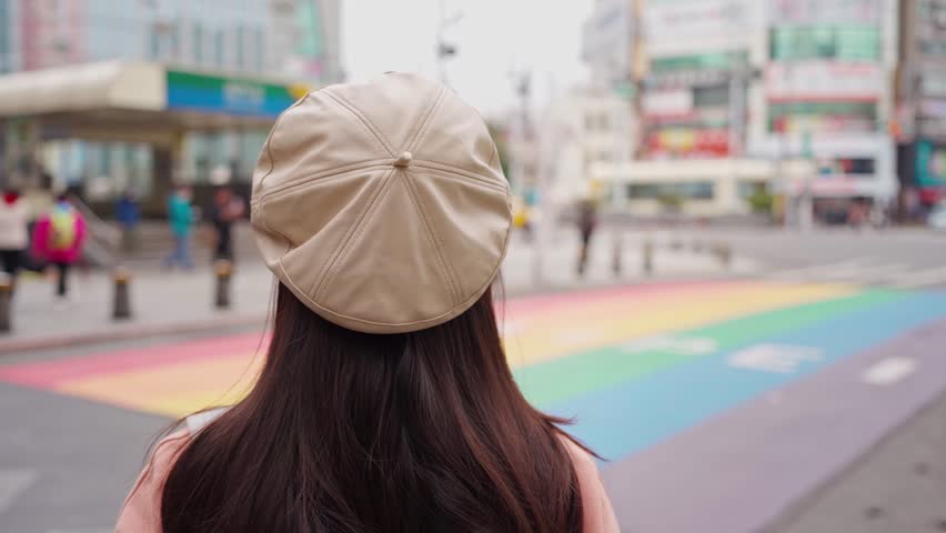 Young female tourist taking a photo of the Rainbow Road crossing at ximending in Taipei, Taiwan Royalty-Free Stock Footage #3432650297