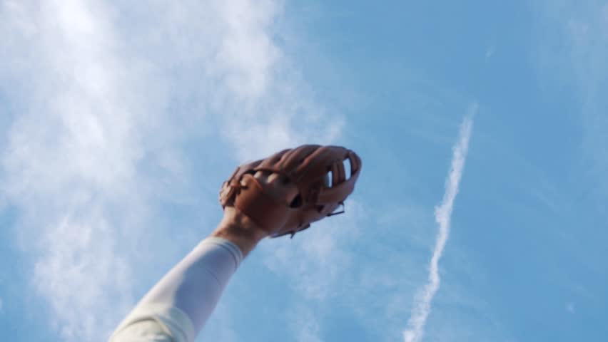 Baseball Catch Success By Fielder Wearing Glove, High Ball From Sky Slow Motion. American Sport And Exercise Outside With Blue Sky. Young Man White Caucasian.