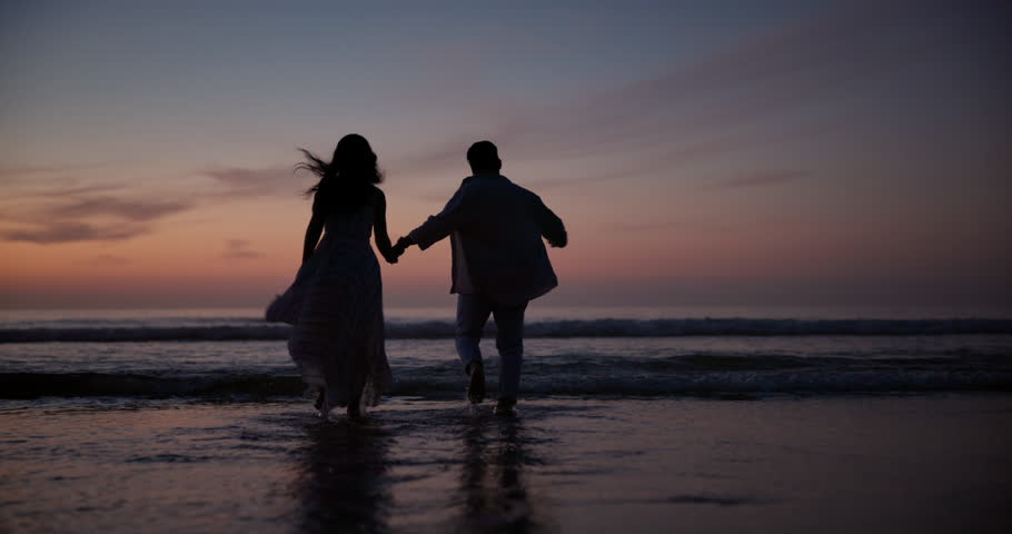 Sunset, holding hands and silhouette of couple at beach on vacation, adventure or holiday for romantic date. Love, shadow and back of people run on tropical weekend trip for valentines day together.