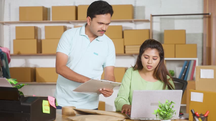 Coworkers working together at ecommerce warehouse by checking or placing order list from inventory - concept of online small business, communication and collaboration - Powered by Shutterstock - Get 15% off with code: PIKWIZARD15