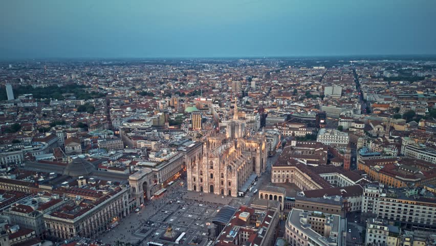 Aerial Hyper lapse Time Lapse of Milan Cathedral Illuminated Piazza Del Duomo Di Milano And `Milano Skyline At Dusk, 4K Footage in Milan Italy Royalty-Free Stock Footage #3432874729