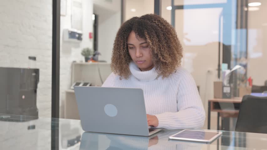 African Woman Working on Laptop in Office