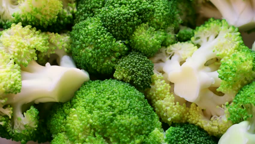 Fresh boiled green broccoli slices circle rotation close up top view