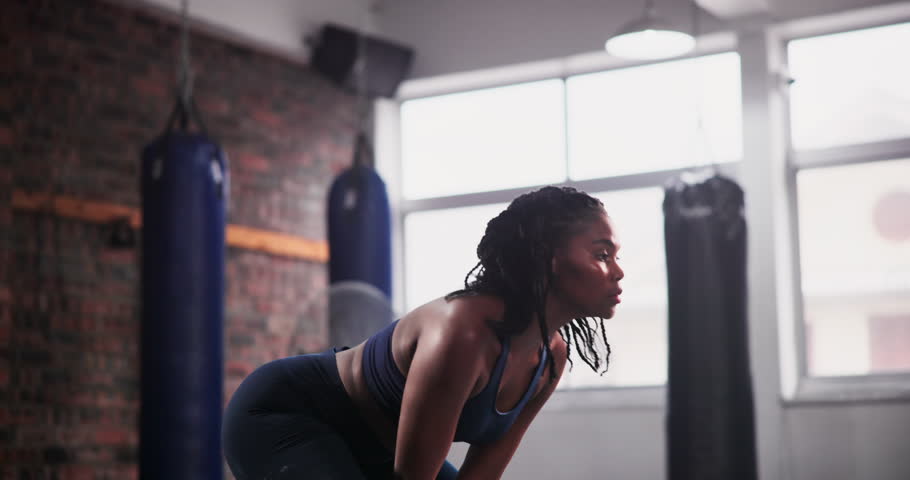 Black woman, kettlebell and weightlifting at gym for workout, strength or body exercise. Active African female person, athlete or bodybuilder in sports, muscle gain or training in health and wellness Royalty-Free Stock Footage #3432953485