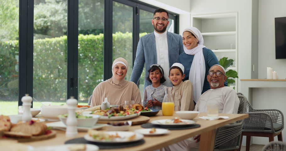 Muslim family, eid lunch and happy for celebration, islamic festival and food for religious holiday. People, portrait and bonding at table for special event, generations and traditional meal at home Royalty-Free Stock Footage #3432994015