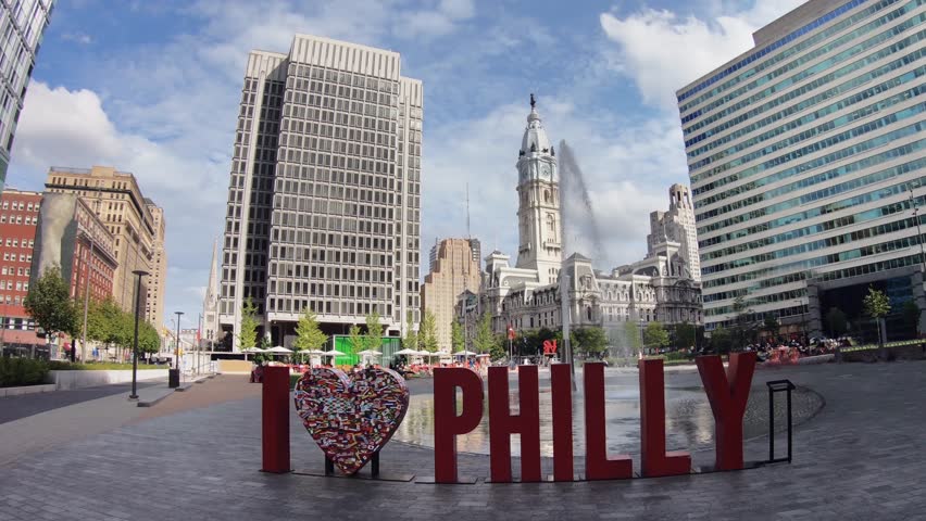 I love Philly Sign in downtown Philadelphia, Pennsylvania with view of the Philadelphia City Hall on a sunny summer day
