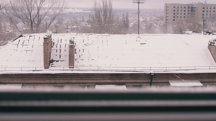 Courtyard view of the Snow Covered Roofs of Old Residential Buildings. Top view, window. Brick multi-storey buildings with balconies in snow. Panorama. Cloudy weather. Winter landscape. Old city. Royalty-Free Stock Footage #3433072571