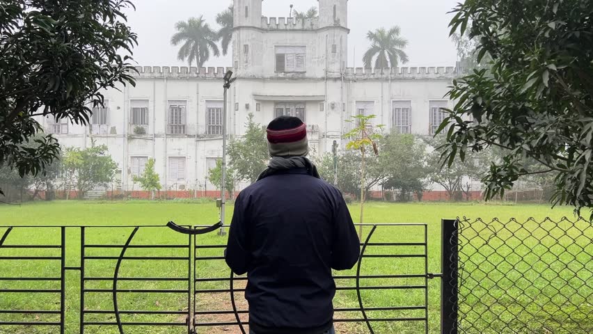Rear view of a man looking at vintage architecture Shibpur college during morning in Kolkata, India.