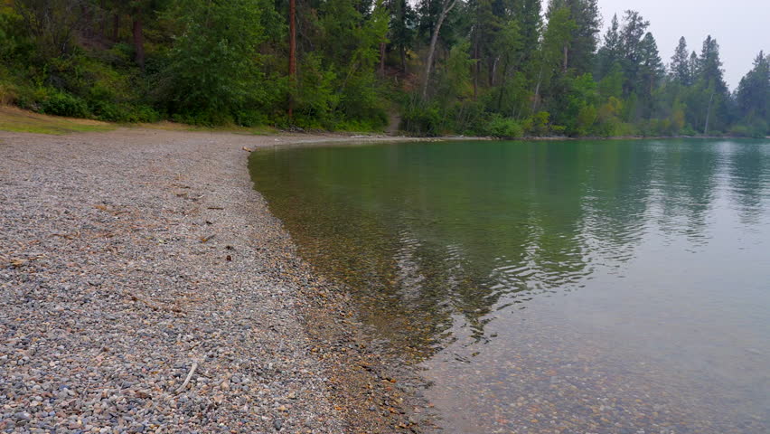 Establishing shot of Mountain Lake with Dramatic Smoke in Vancouver, Canada, North America. Day time on May 2023. Still camera view. ProRes 422 HQ.