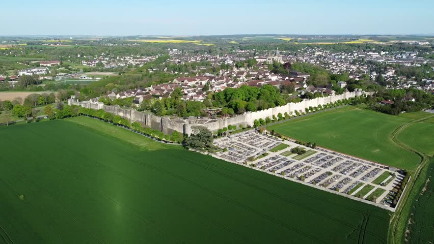 Aerial view of the fortified walls of Provins, a medieval city that hosted one of the largest Champagne fairs now located in Seine et Marne, France - Stone walls surrounding a city in the countryside