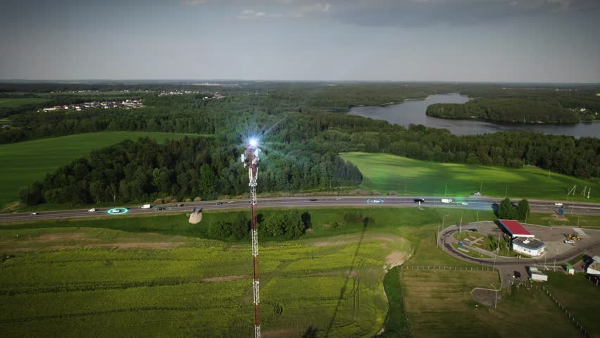 Telecommunication communication tower distributes signals to cars driving nearby. Autonomous vehicles exchange data. Concept:Car Scan, GPS Tracking, Smart Roads, Radio Waves, IoT, Traffic Control 4k. 