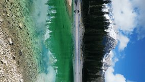 Aerial view of Karersee lake with mountain and forest, Lago di Carezza, Dolomites, Italy, Vertical video 4k - Powered by Shutterstock - Get 15% off with code: PIKWIZARD15
