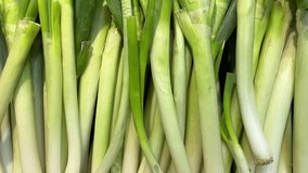 leeks vegetables and fruits on the counter in a supermarket or market in Vietnam Leek piled up at the vegetable counter. High quality 4k footage