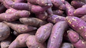Sweet potatoes are hot steamed cooked footage slow motion. vegetables and fruits on the counter in a supermarket or market in Vietnam High quality 4k footage