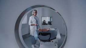 Close up shot of patient lying on CT, PET, or MRI scan bed, moving inside machine. Advanced gear scans body and brain in medical facility with modern technologies. Detailed examination and diagnosis. - Powered by Shutterstock - Get 15% off with code: PIKWIZARD15