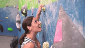 Woman climbing indoor safely in climbing wall. Bouldering sportswomen initiation climbers. - Powered by Shutterstock - Get 15% off with code: PIKWIZARD15