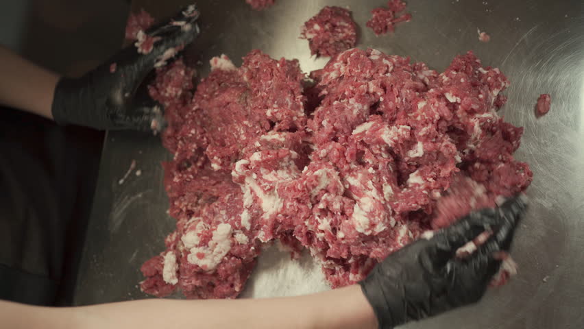 Chef prepares minced meat for meatballs and cutlet in a kitchen, close-up. Promotional video. Artistic video with meat for hamburger patties Royalty-Free Stock Footage #3433568217