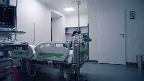 Emergency room with modern equipment in hospital. Elderly man in oxygen mask sleeps in bed after successful surgery. Nurse takes care of old patient. Intensive care department in medical facility. - Powered by Shutterstock - Get 15% off with code: PIKWIZARD15