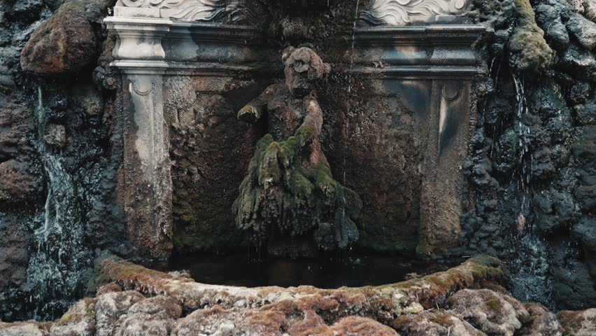 Fountain with statue, face and ornames at the front main entrance of Villa Cora in Florence tuscany italy - slow forward dolly shot