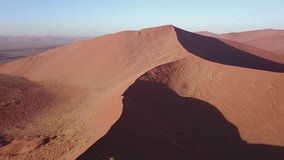4K high quality aerial video drone footage of famous endless sand sea and Sossusvlei Namib Desert scenic red sand dunes on sunny morning in Namib-Naulkuft Park in Namibia, southern Africa