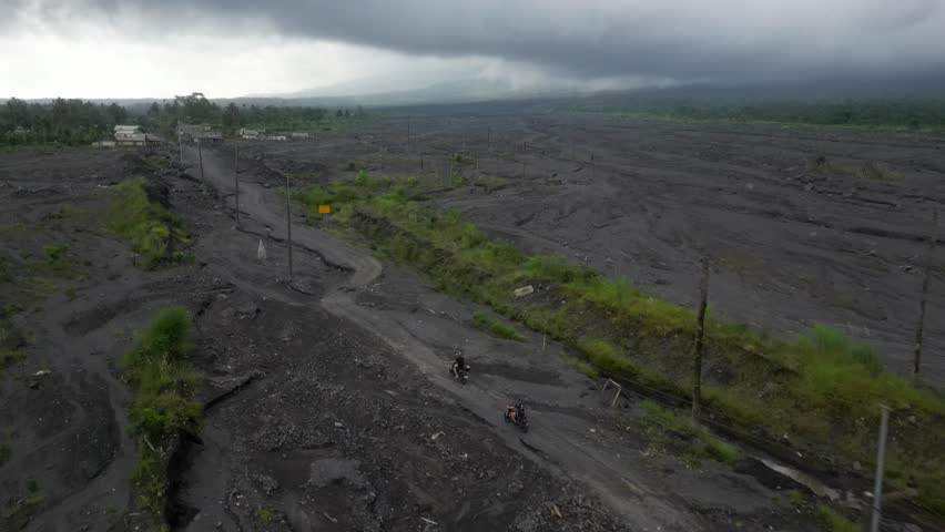 Aerial: Dark overcast sky over ash lava flow at Curah Kobokan in Bali Royalty-Free Stock Footage #3433625831