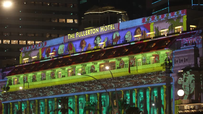 Marina Bay, Singapore - December 30, 2023: 4k establishing cinematic shot of Fullerton Hotel Marina Bay during light show at New Year festive season. 