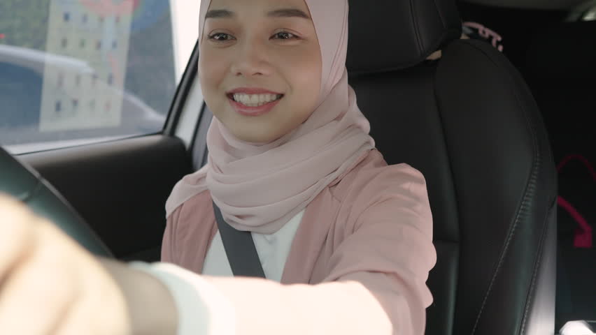 Beautiful Asian Muslim woman pay for food or drinks via smart phone using barcode reader scanning barcode by driving through or drive thru. headscarf. Contactless payment. Royalty-Free Stock Footage #3433640847