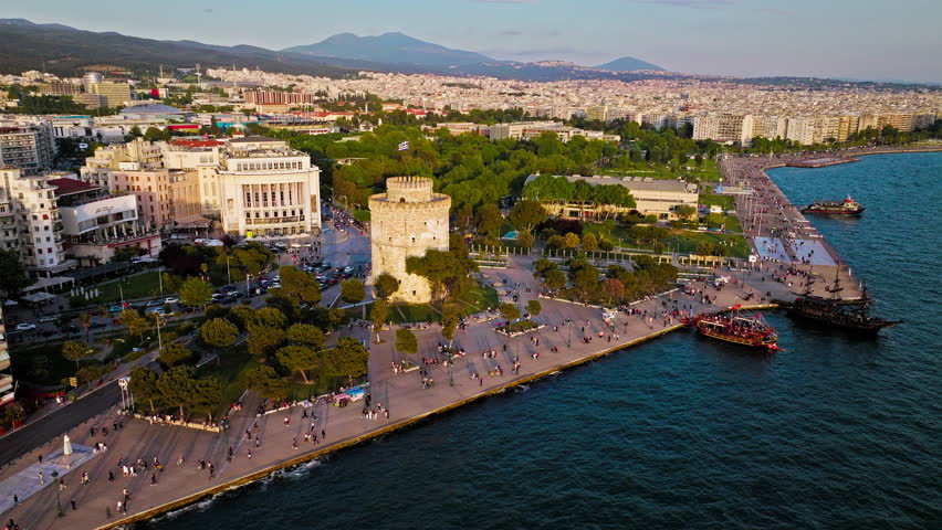 Aerial View of Landmark Ottoman Fortress White Tower of Thessaloniki. Waterfront of the city of Thessaloniki, Whitewashed Tower, Greek port city with tall buildings in Greece.