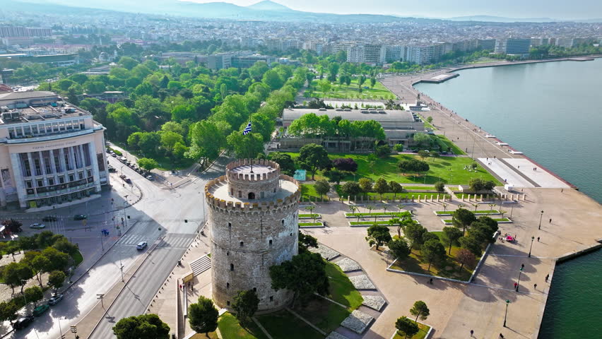 Aerial View of Landmark Ottoman Fortress White Tower of Thessaloniki. Waterfront of the city of Thessaloniki, Whitewashed Tower, Greek port city with tall buildings in Greece.
