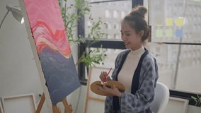 Innovative asian female painter using red paint on big canvas,holding tube of oil paint,fine art artist drawing,Abstract acrylic painting in the art studio.asian woman painting brush on canvas - Powered by Shutterstock - Get 15% off with code: PIKWIZARD15