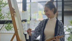 Innovative asian female painter using red paint on big canvas,holding tube of oil paint,fine art artist drawing,Abstract acrylic painting in the art studio.asian woman painting brush on canvas - Powered by Shutterstock - Get 15% off with code: PIKWIZARD15