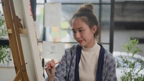 Innovative asian female painter using red paint on big canvas,holding tube of oil paint,fine art artist drawing,Abstract acrylic painting in the art studio.asian woman painting brush on canvas - Powered by Shutterstock - Get 15% off with code: PIKWIZARD15
