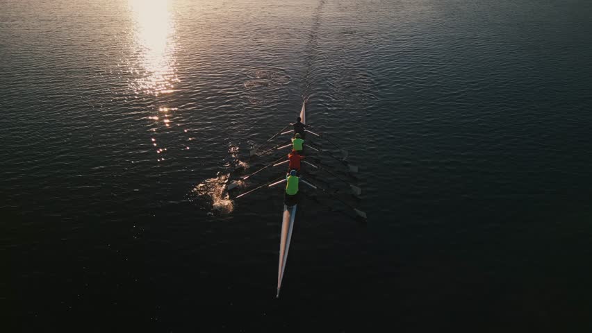 Cinematic shot of the throne group of sport canoes driven by young athletes training at sunrise in an ocean bay, Halifax, Canada.Rowing club practicing in the ocean bay at sunrise early in the morning Royalty-Free Stock Footage #3433767445
