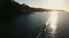 Cinematic shot of the throne group of sport canoes driven by young athletes training at sunrise in an ocean bay, Halifax, Canada.Rowing club practicing in the ocean bay at sunrise early in the morning - Powered by Shutterstock - Get 15% off with code: PIKWIZARD15