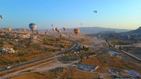 The enchanting spectacle of a hot air balloon festival. The vibrant balloons rise gracefully over the valleys of Cappadocia, painting a breathtaking scene with their kaleidoscope of colors.