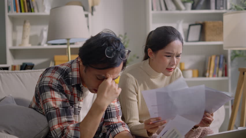 upset millennial couple counting overspent budget,Unhappy young woman feeling stressed calculating monthly expenses at home,lack of money for utility household or rental payments, bankruptcy concept Royalty-Free Stock Footage #3433873163