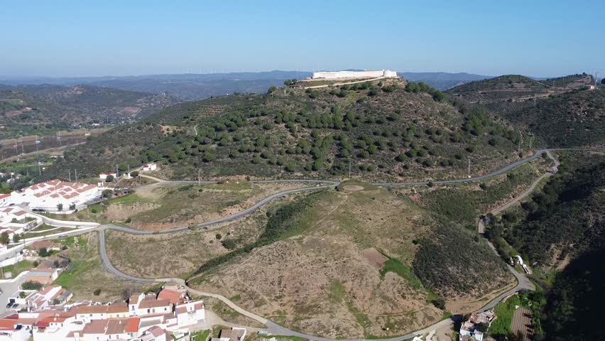 Aerial panoramic view of San Marcos Castle in a mountain of Sanlucar de Guadiana village in Huelva province, Andalusia, on the banks of Guadiana river, in the border of spain with portugal