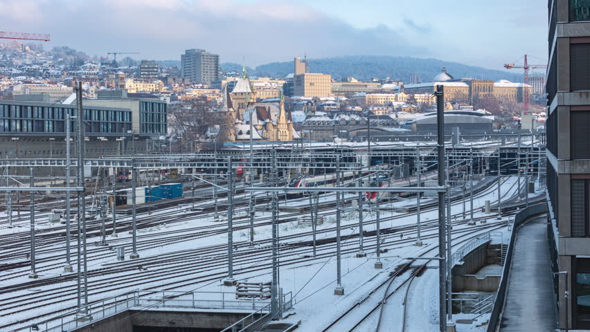 Time lapse, railway station in winter. European town covered with snow. Zurich main train station. Hauptbahnhof, Zurich, Switzerland.